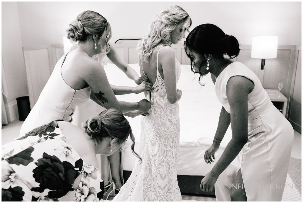 Bride putting her dress on for her COMO the Treasury wedding