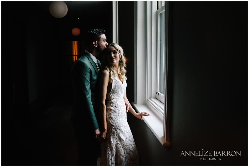 Bride and Groom looking out the window at this COMO the Treasury wedding