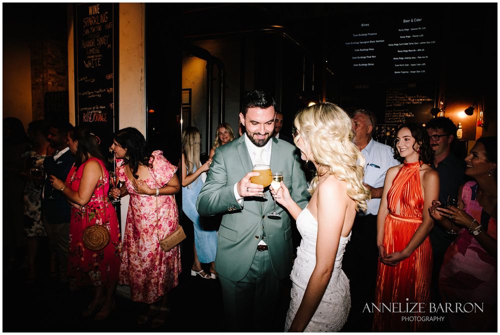 Bride and groom toasting with their first drink