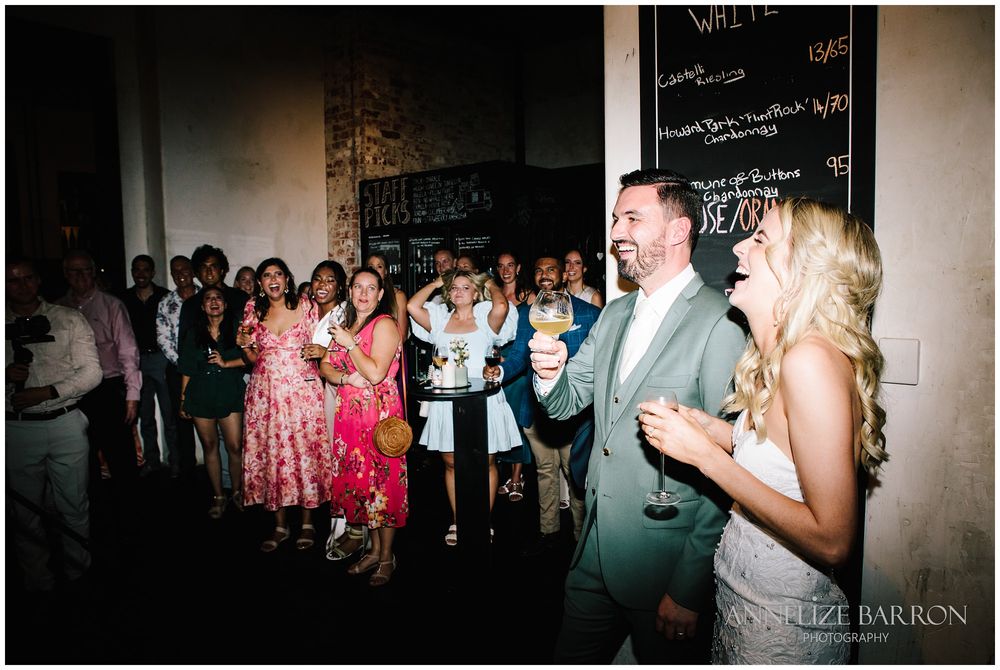 Bride and groom laughing during the speeches