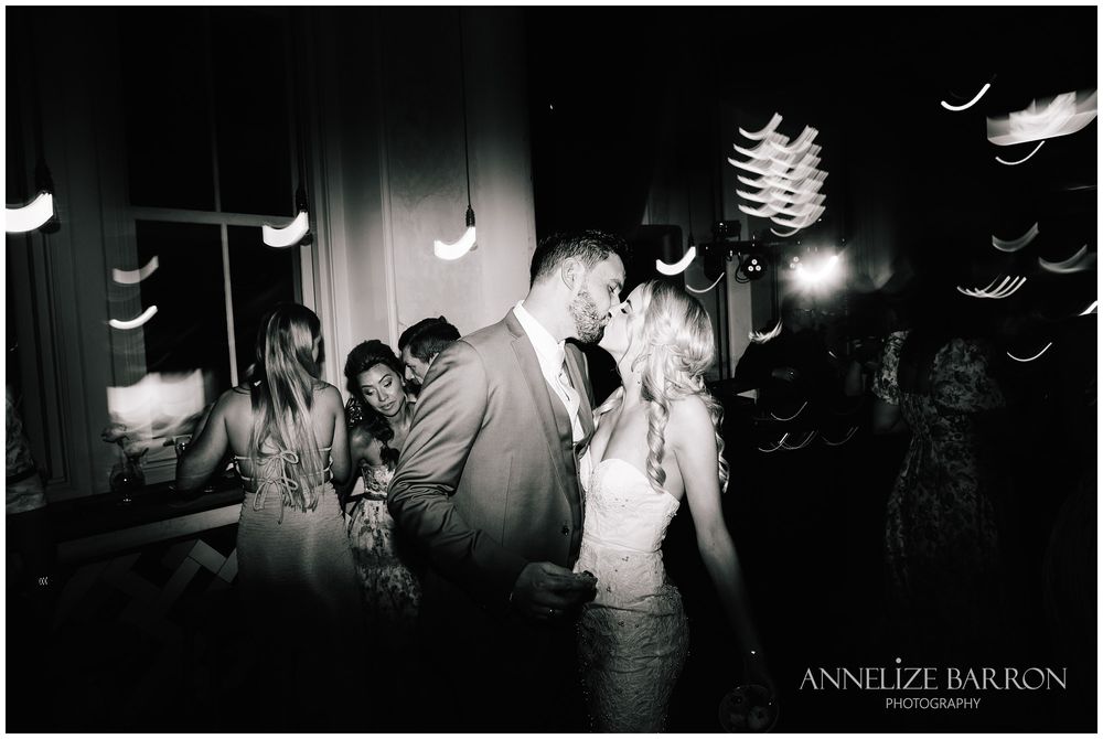 Bride and groom kissing on the dance floor at their COMO the Treasury wedding