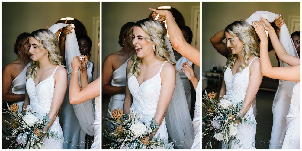 Bridesmaids putting in the bride's veil before her COMO the Treasury wedding