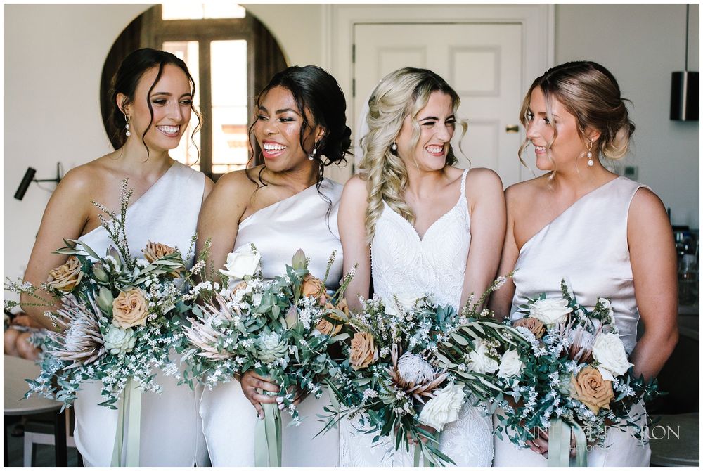 Bride and bridesmaids excitedly giggling