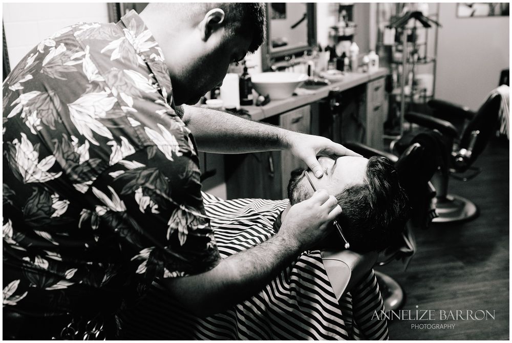 Barber shaving the groom