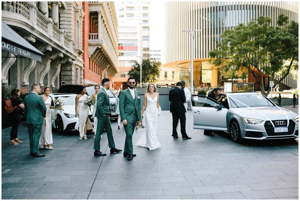 Bridal party with the cars in front of COMO the Treasury