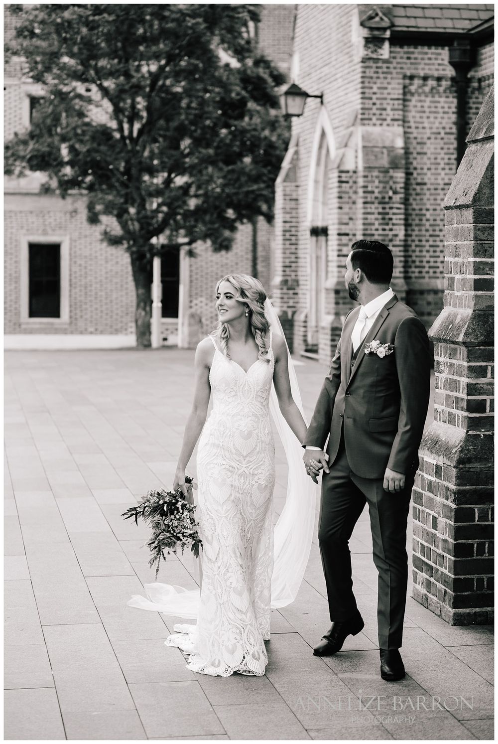 Bride and groom walking at Cathedral Square
