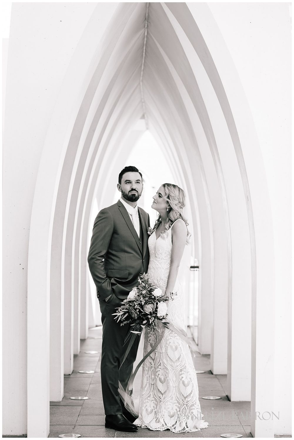 Bride and groom in the arches at Cathedral square