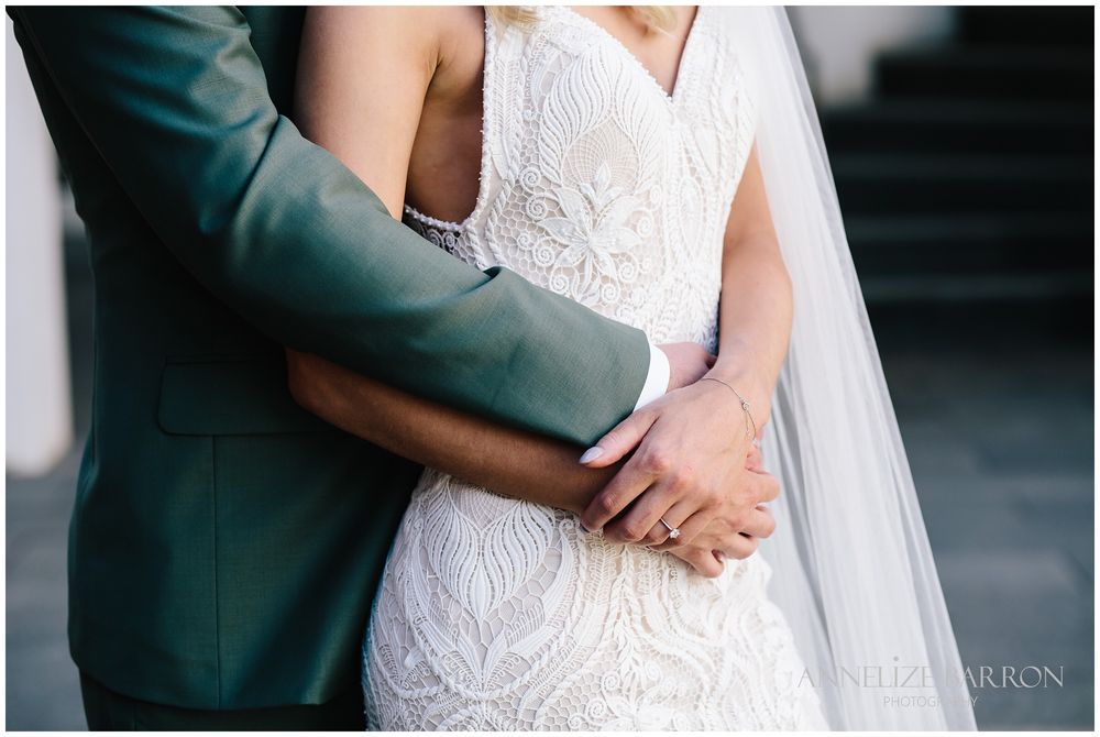 Closeup of the groom holding his bride