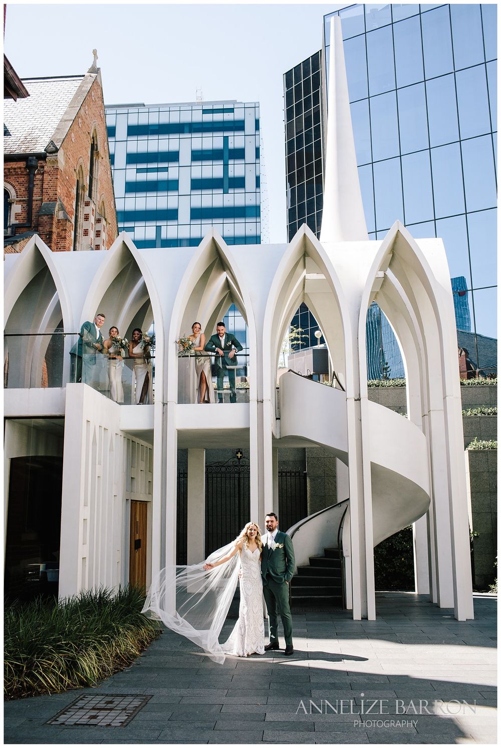 Bride and groom with the bridal party in the Arches at Cathedral Square