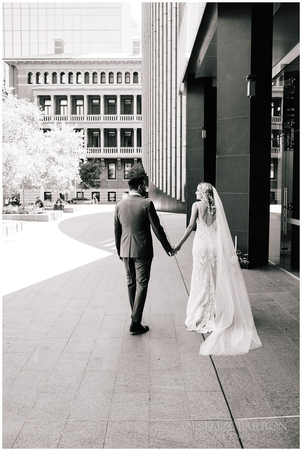 Bride and groom strolling in Cathedral square