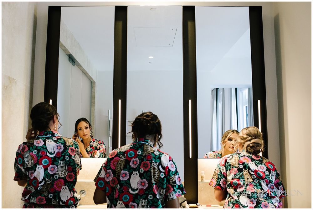 Bridesmaids looking in the mirror
