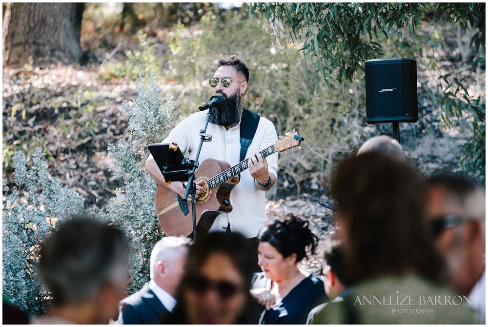 Musician singing and playing a guitar for the guests in Kings Park