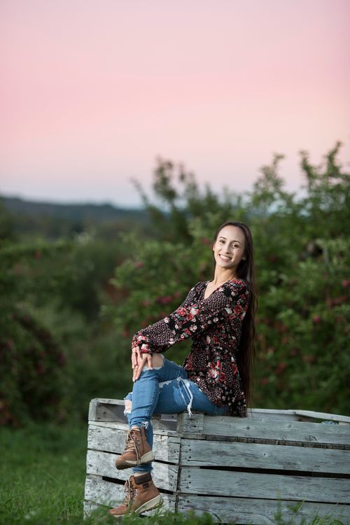 A high school senior portrait on an apple box at Wallingford's orchard.