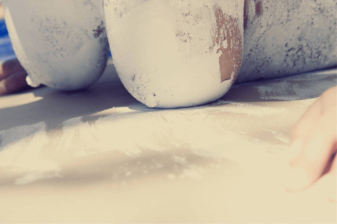 Close-up shot of white porcelain ceramic pieces against a soft neutral backdrop.