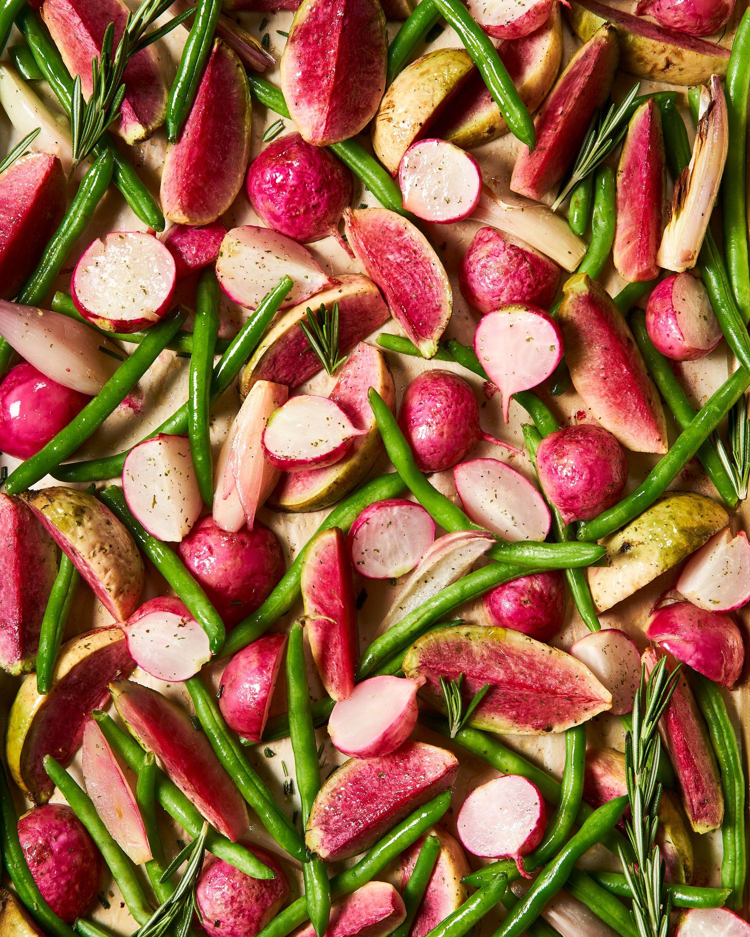 Fresh sliced radishes and green beans arranged in a colorful pattern creating an overhead food background texture.