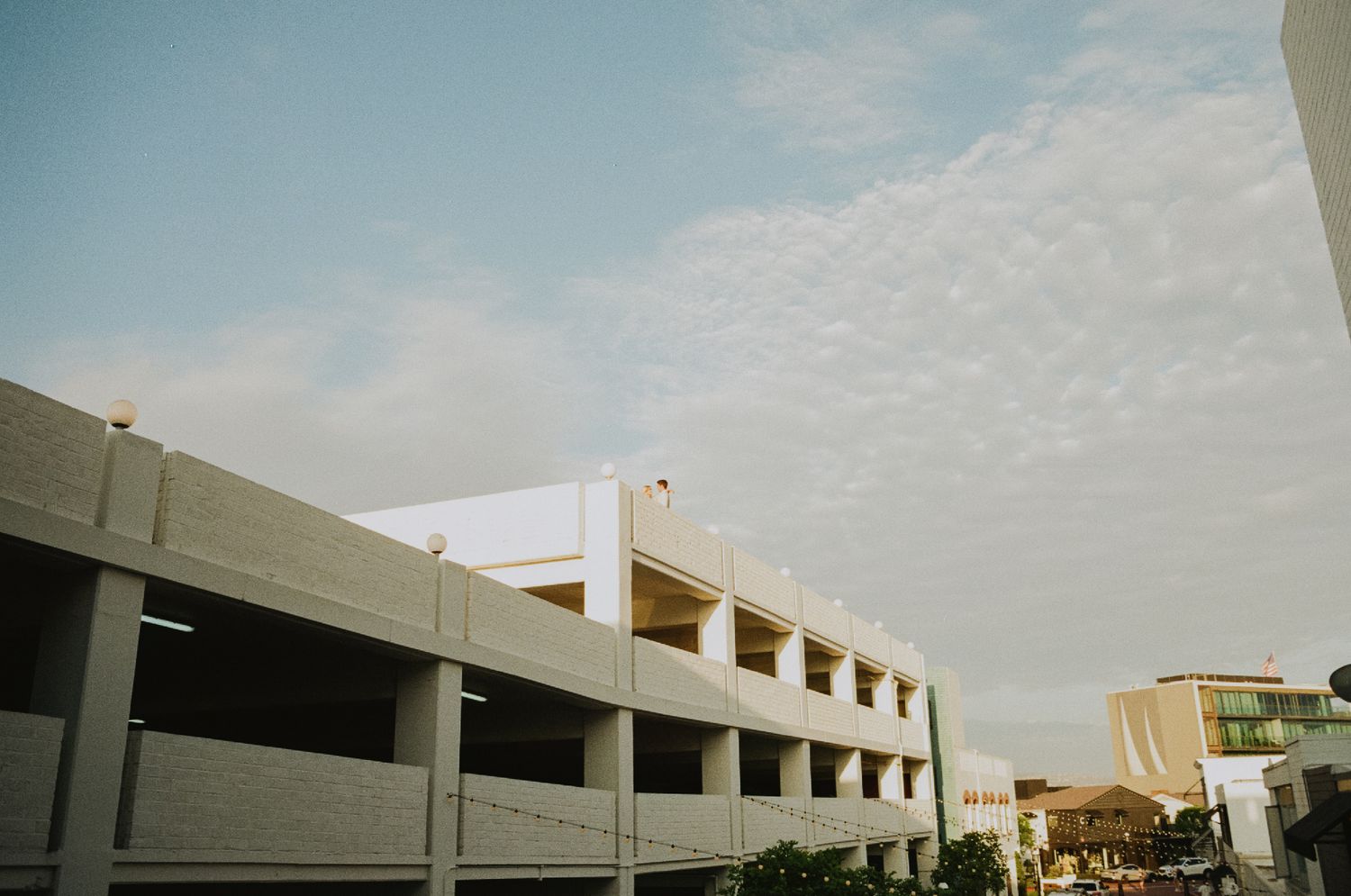 35mm film photo of fun bridal themed engagement shoot on roof of parking structure in Lido Marina, Newport beach