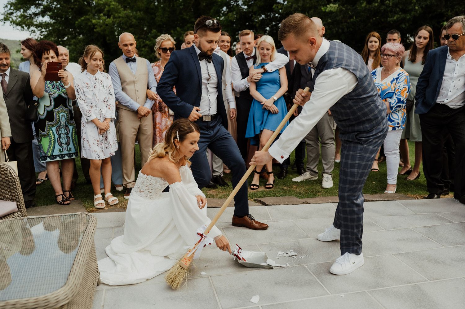 Traditional wedding game being played outdoors with guests gathered in a circle.