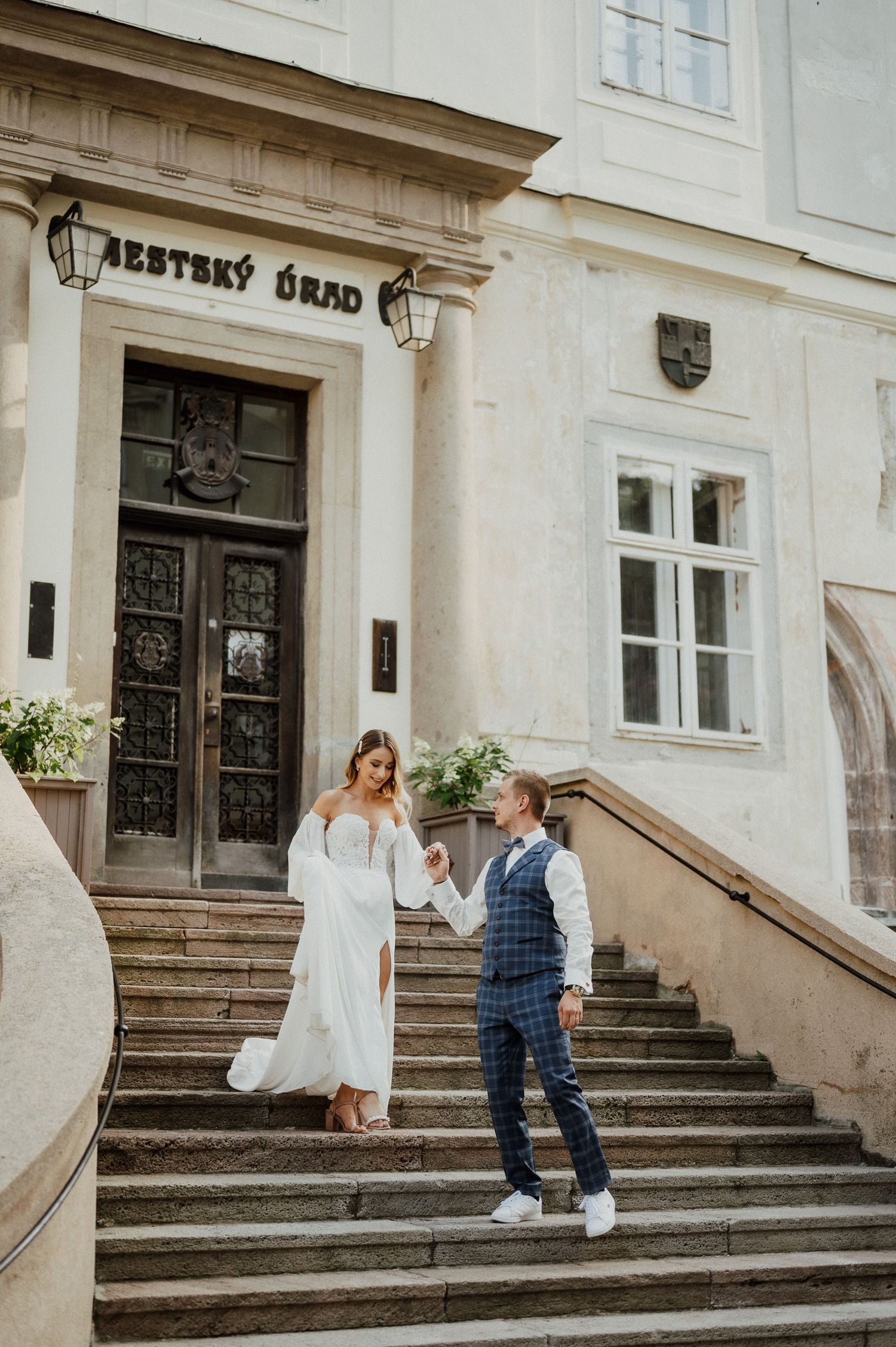 Elegant white building entrance with ornate steps and classical architecture details.