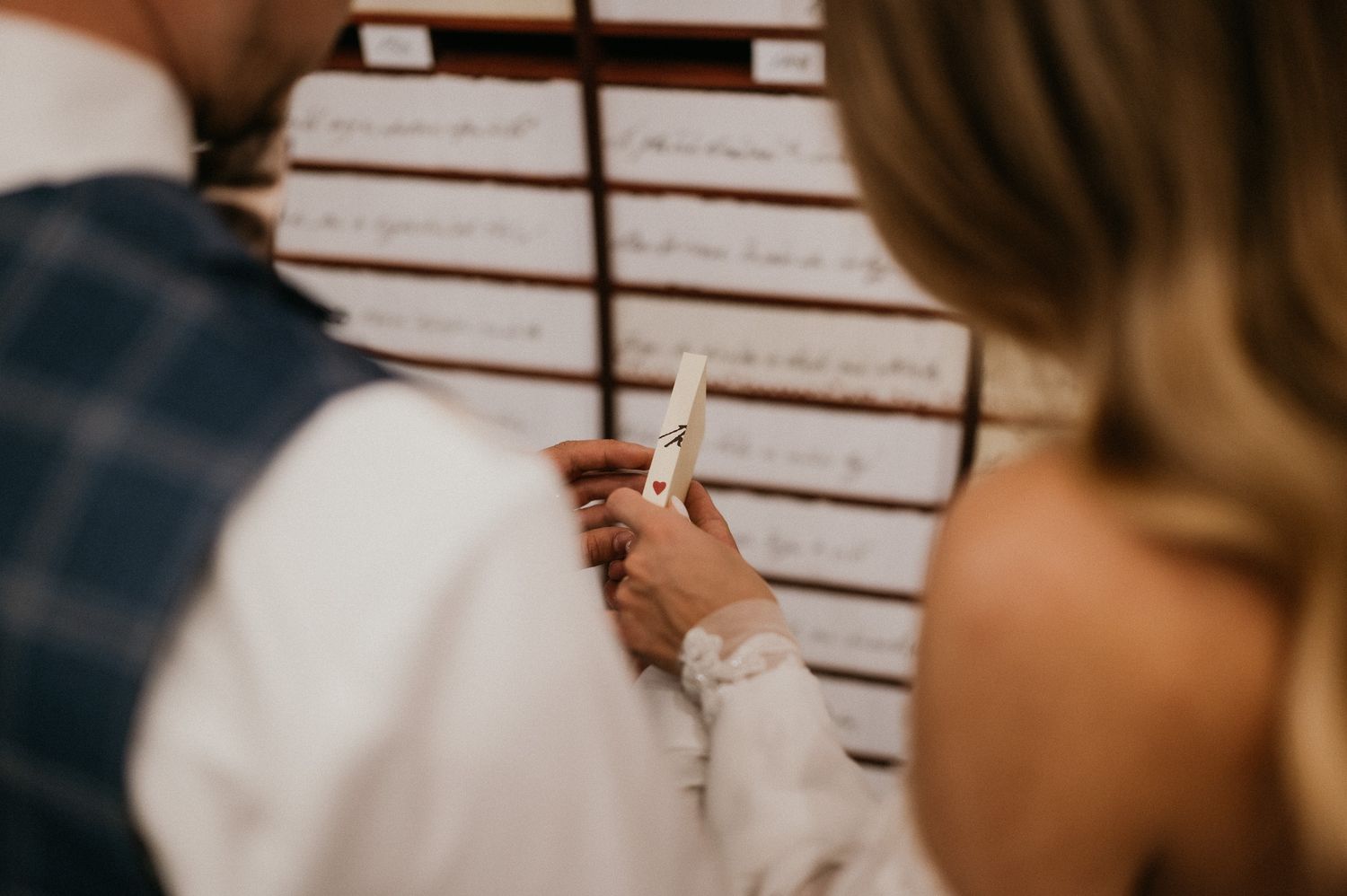 Close-up of hands holding sparkler against white background.