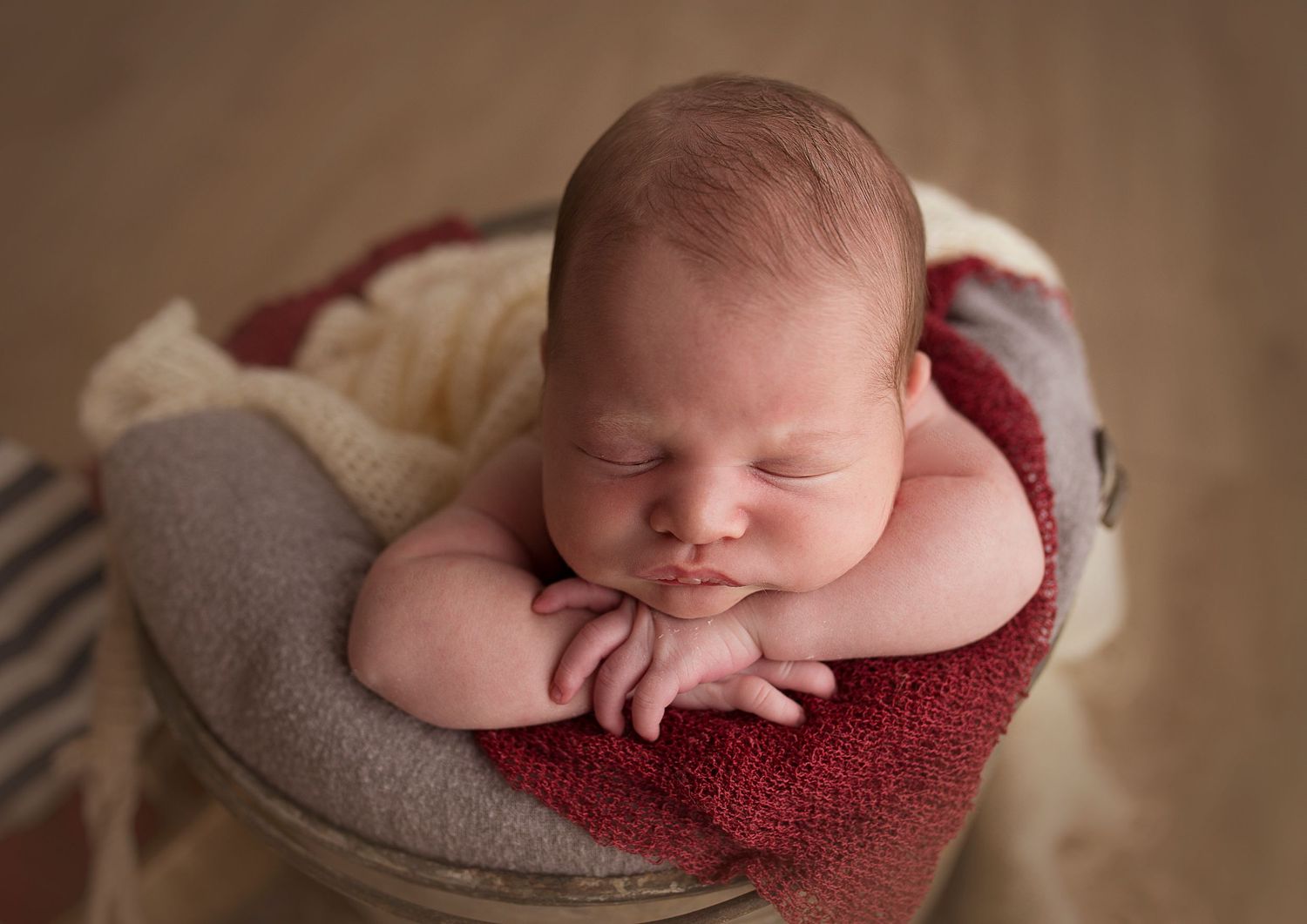 chin on hands pose newborn baby boy detres
