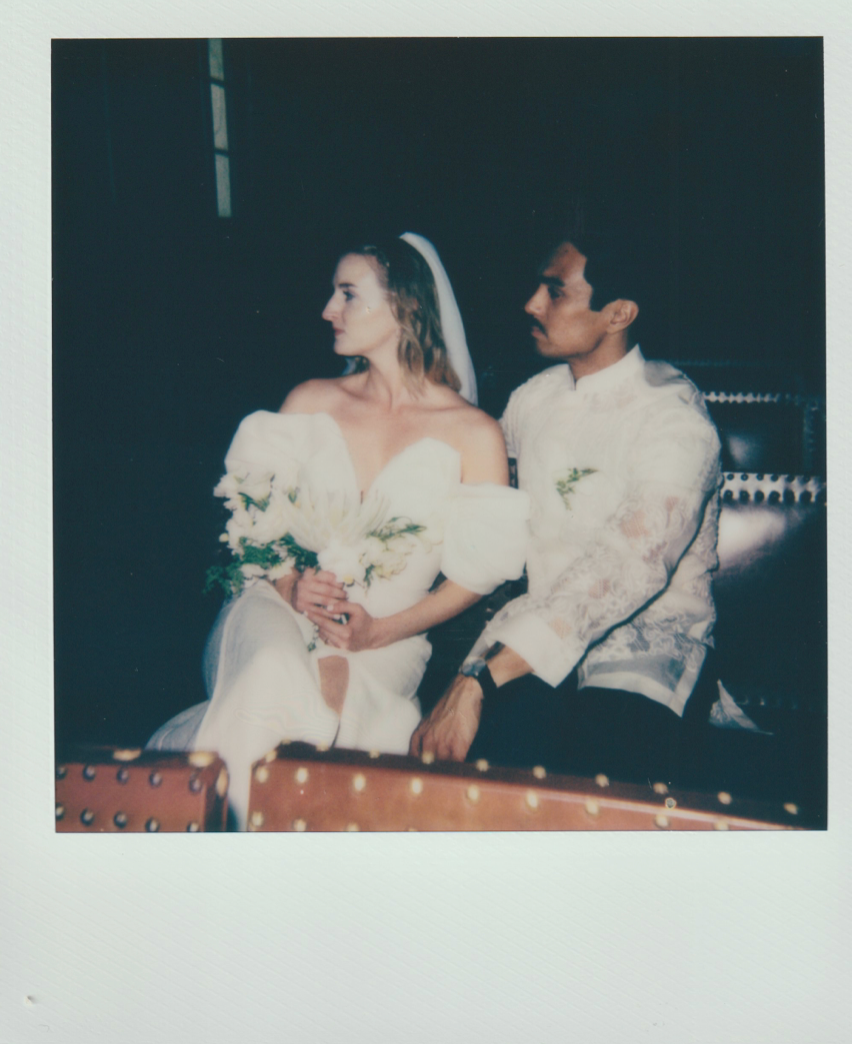 Vintage polaroid of couple in formal wedding attire seated together.