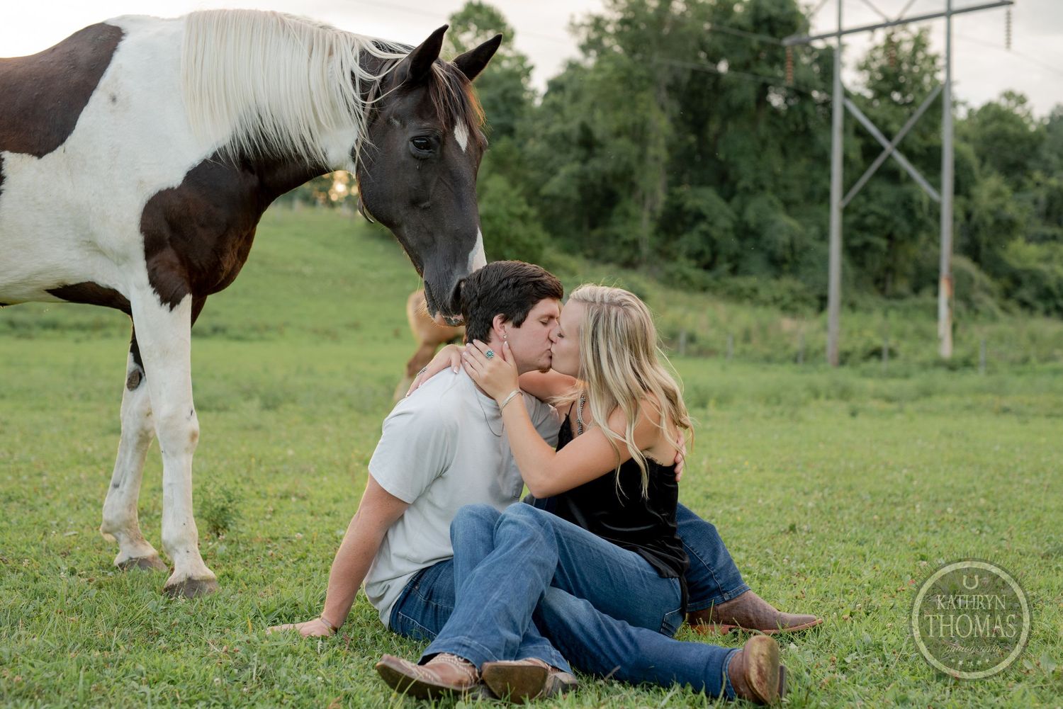A playful moment captured with a curious horse photobombing a couple's portrait.
