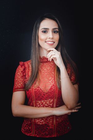 Dramatic studio portraits in red lace showing different poses against black background.