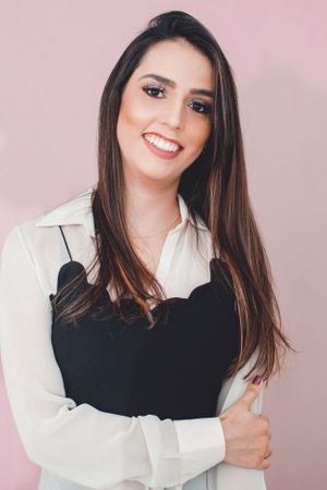 Portrait series against pink background featuring white button-down shirt and casual styling.