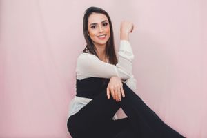Professional portrait series with white button-down shirt against soft pink background.