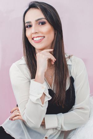 Studio photography showing casual poses in white shirt against light backdrop.
