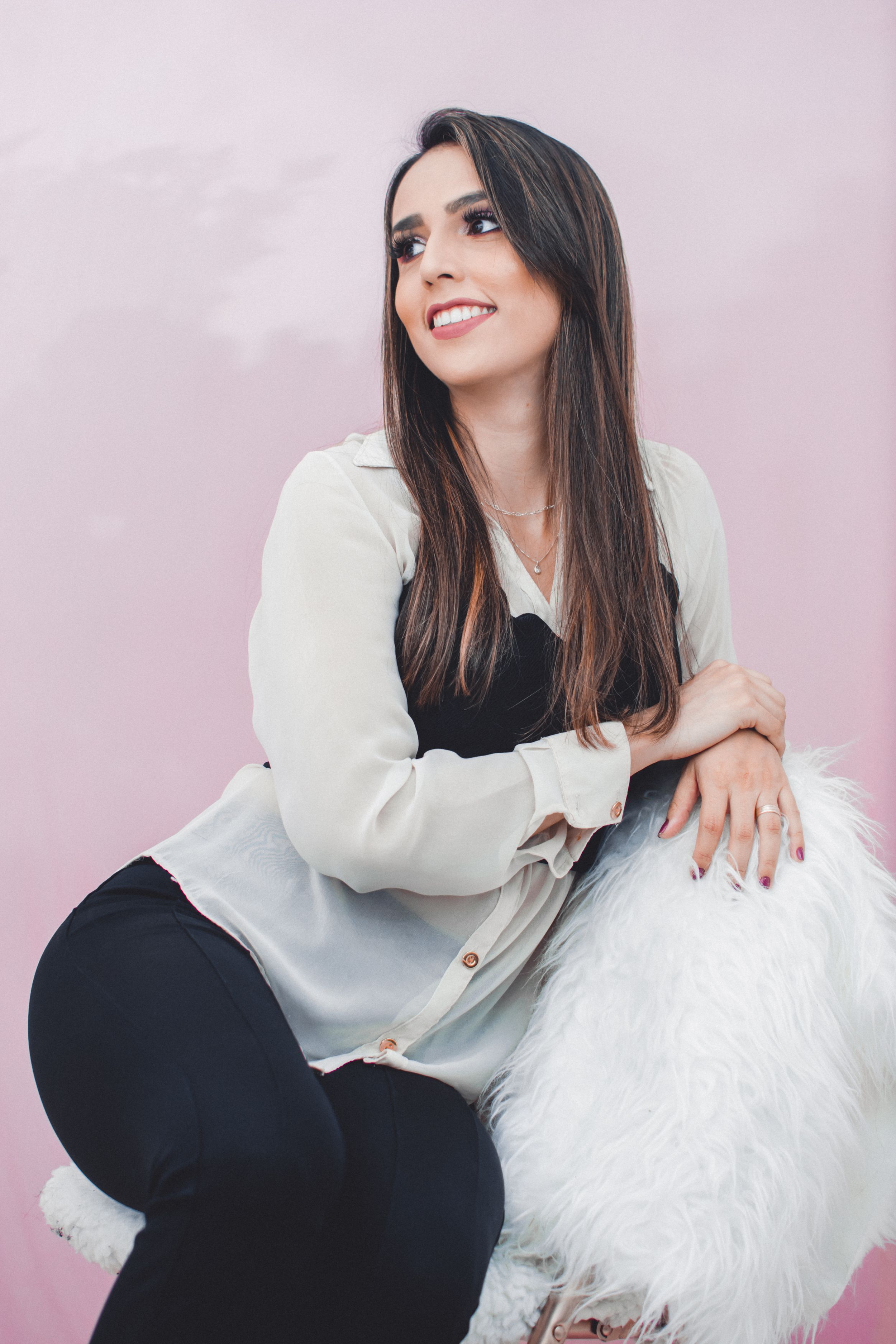 Fashion portrait set featuring modern style with white fur accent and black outfit.