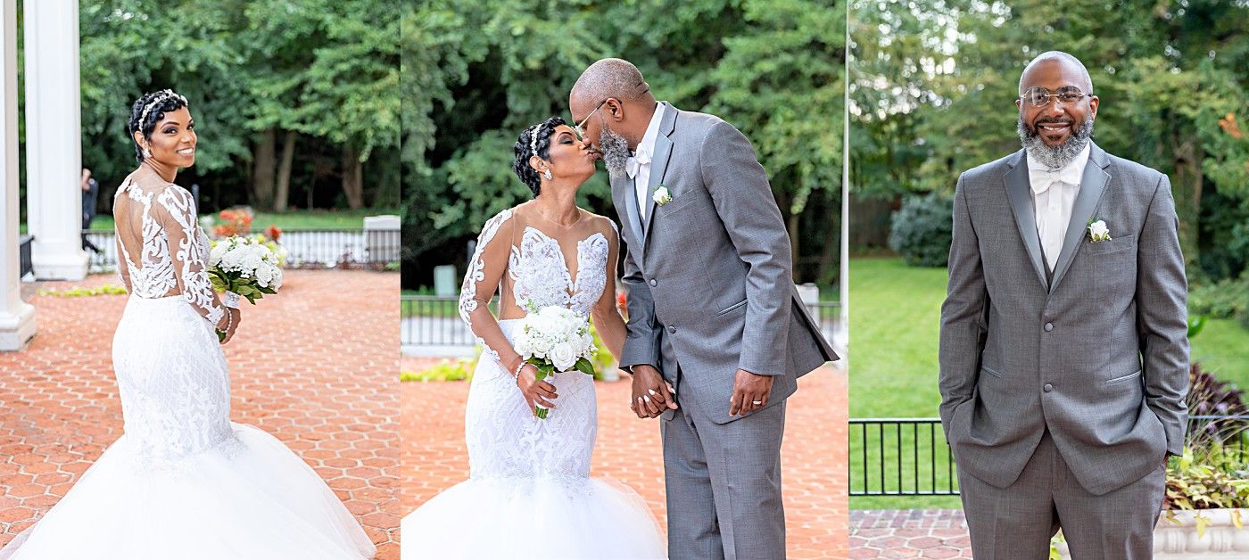 Bride in lace mermaid gown poses near gazebo while groom in gray suit shares a kiss with her outdoors.