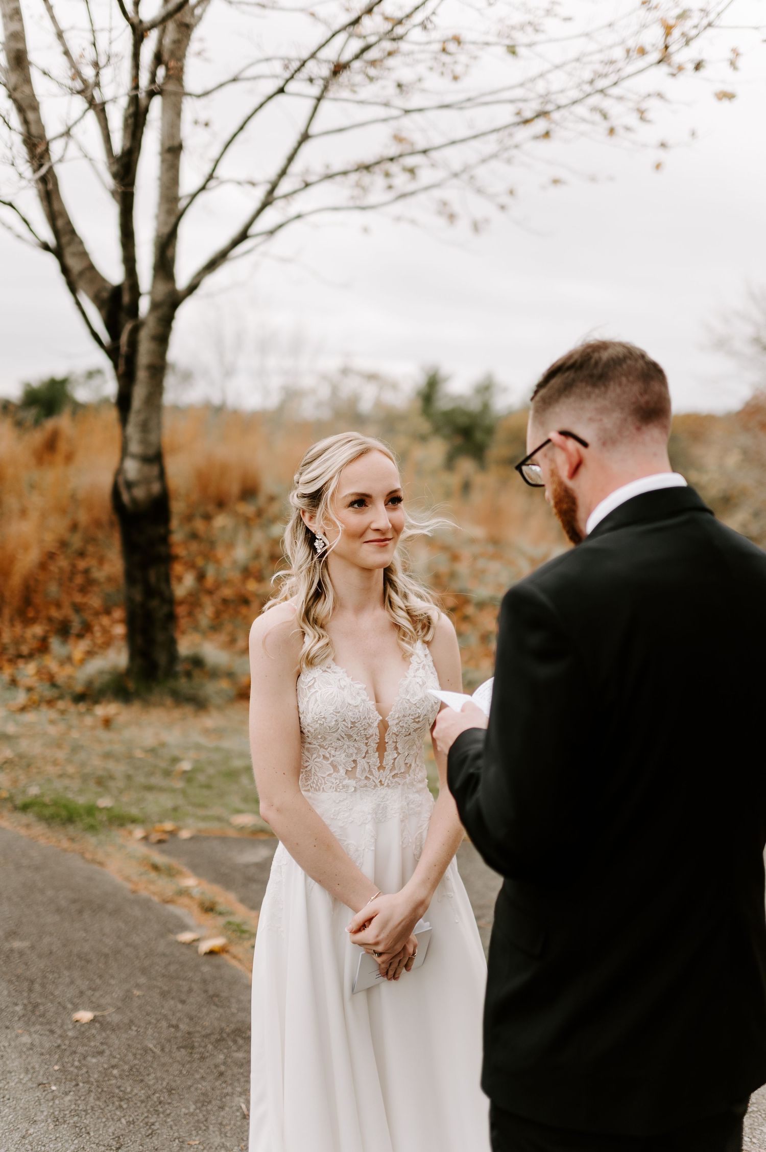 A couple shares emotional reactions while reading personal notes on their wedding day.