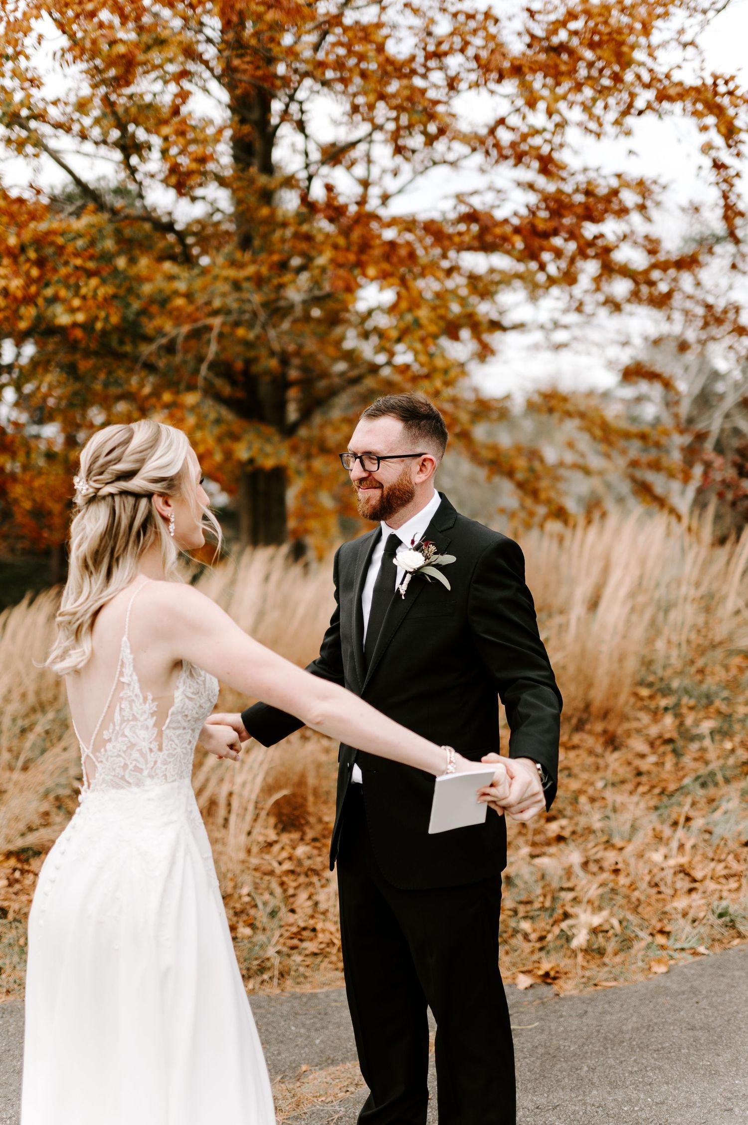 A couple reacts emotionally while reading letters to each other during their autumn wedding.