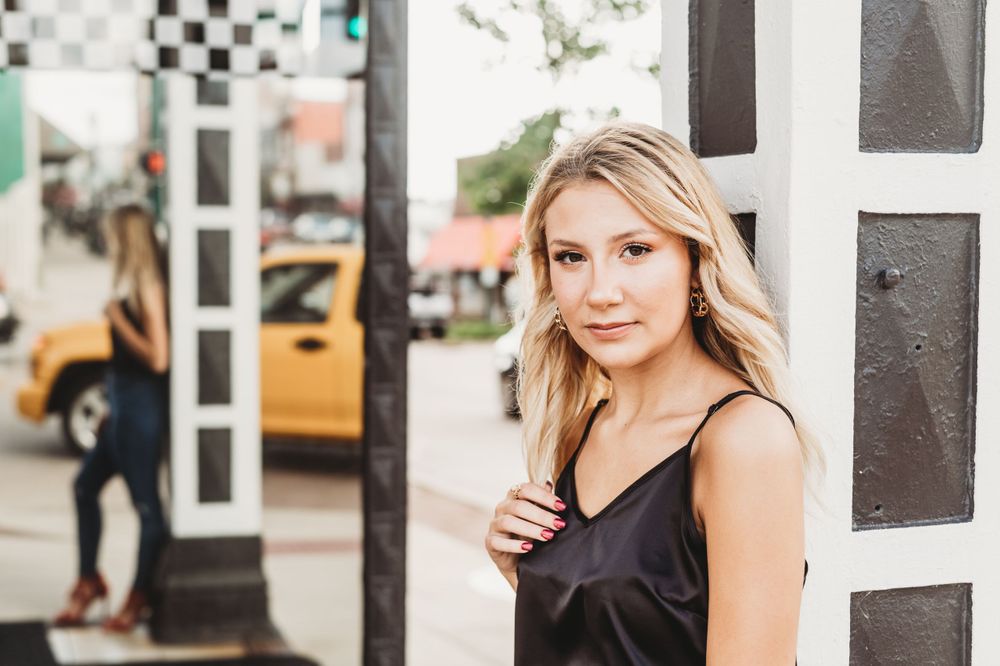 Casual street style portrait with architectural elements.