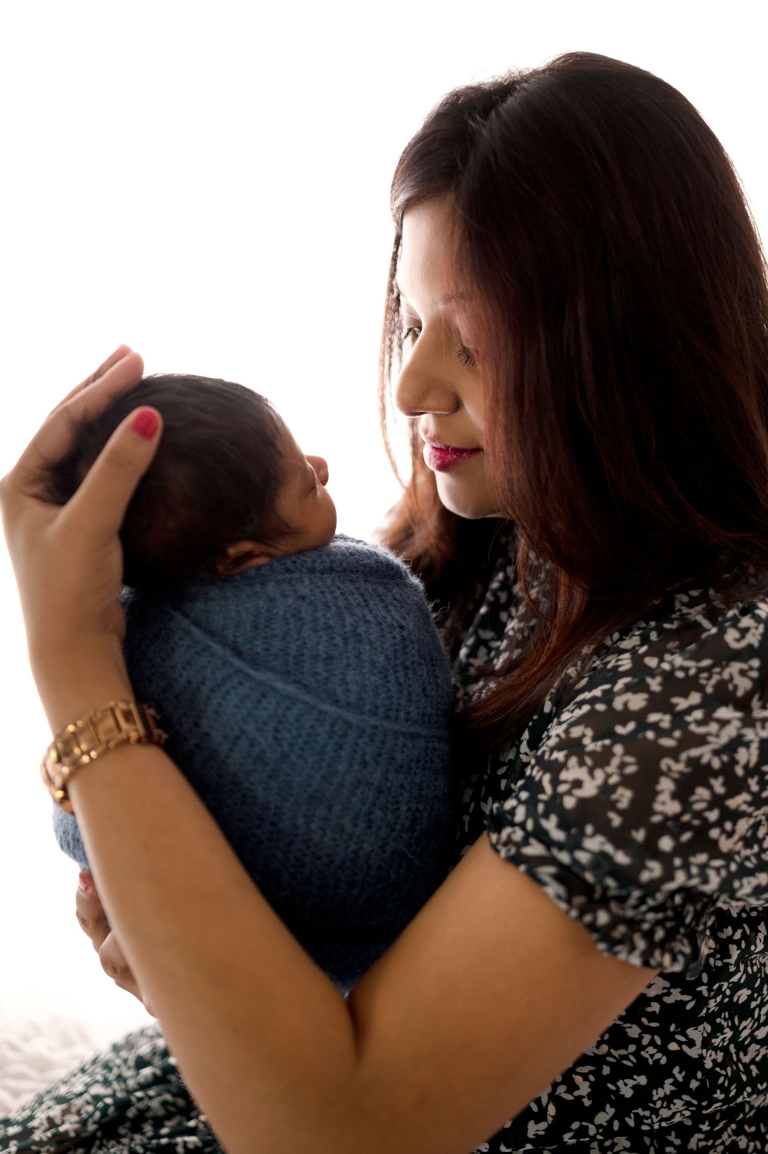Close-up photo collection showing tender embraces between parent and child in matching navy outfits.