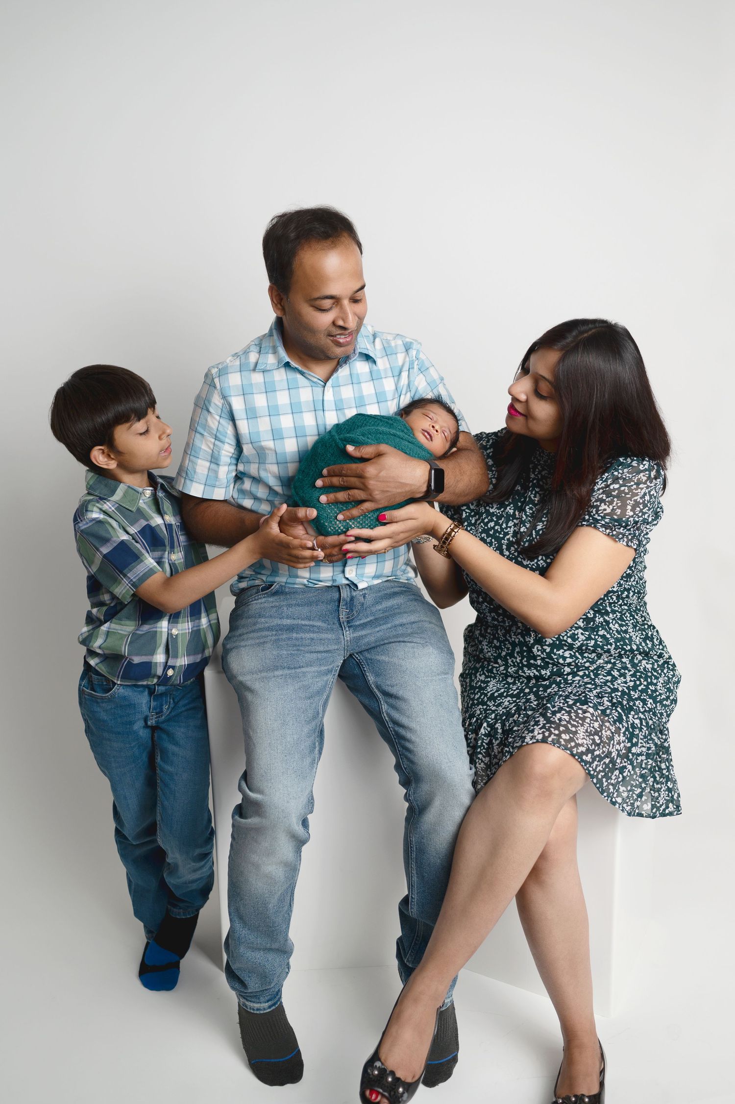 Playful family photo series showing interactions on white background in casual clothing.