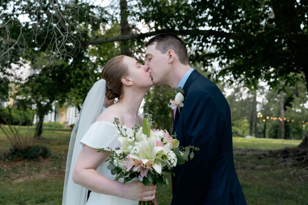Outdoor elopement photography with couple first kiss