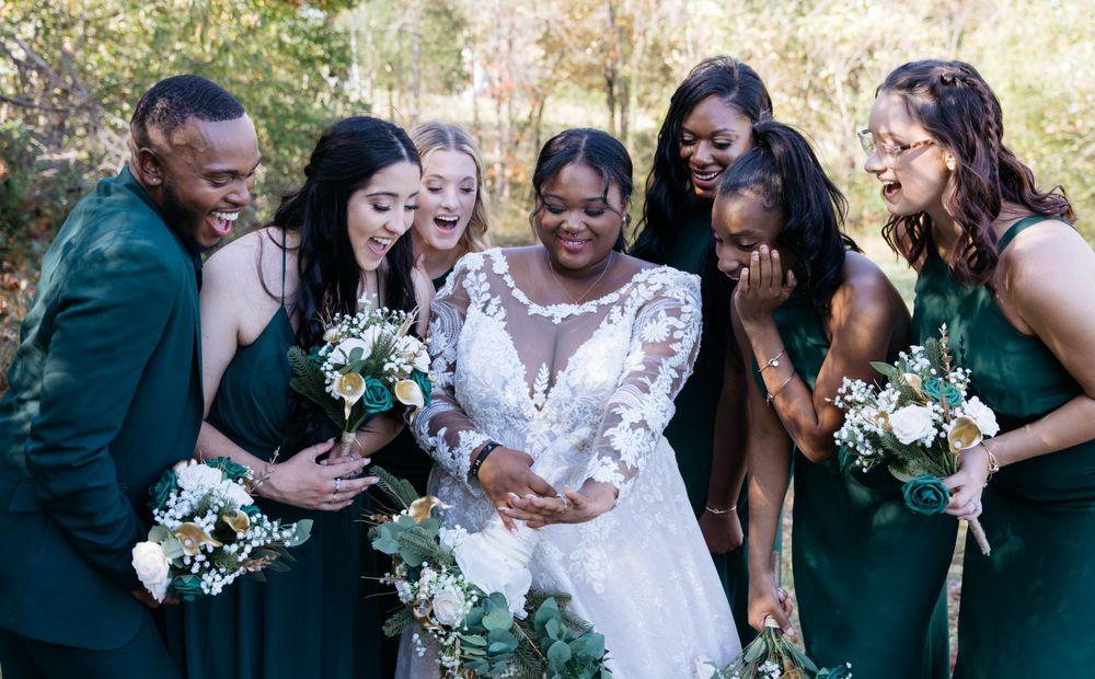 Outdoor wedding photography with bridesmaids admiring bride ring holding bouquets