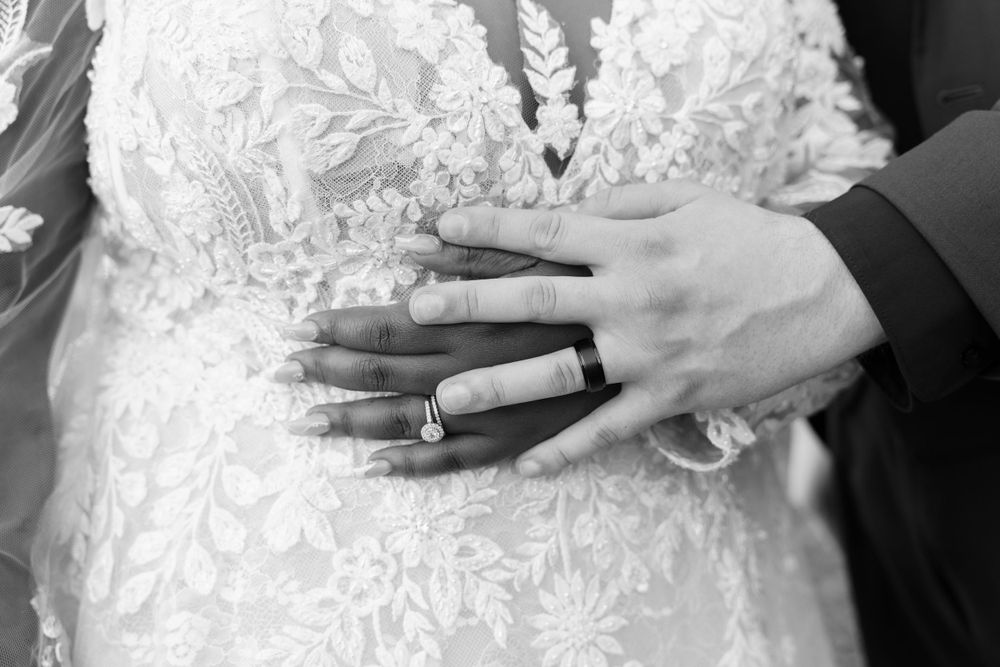 Outdoor wedding photography with focus on couple wedding rings
