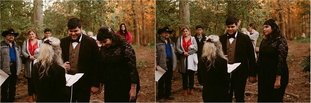 An outdoor wedding ceremony in a forest with fall foliage and a small gathering of attendees.