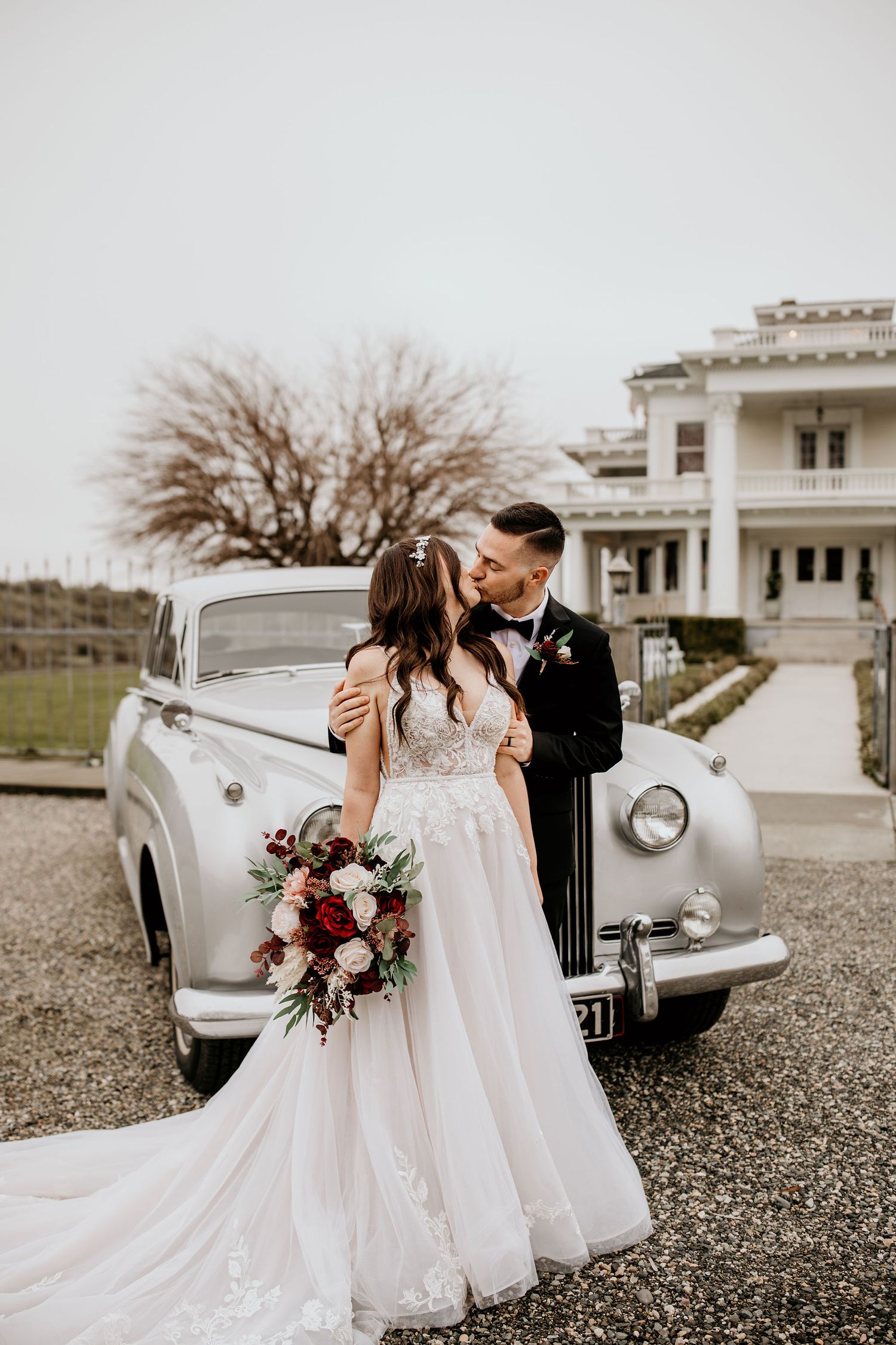 Bride and Groom stand beside vintage Rolls Royce outside of The Moore Mansion in Pasco, WA.