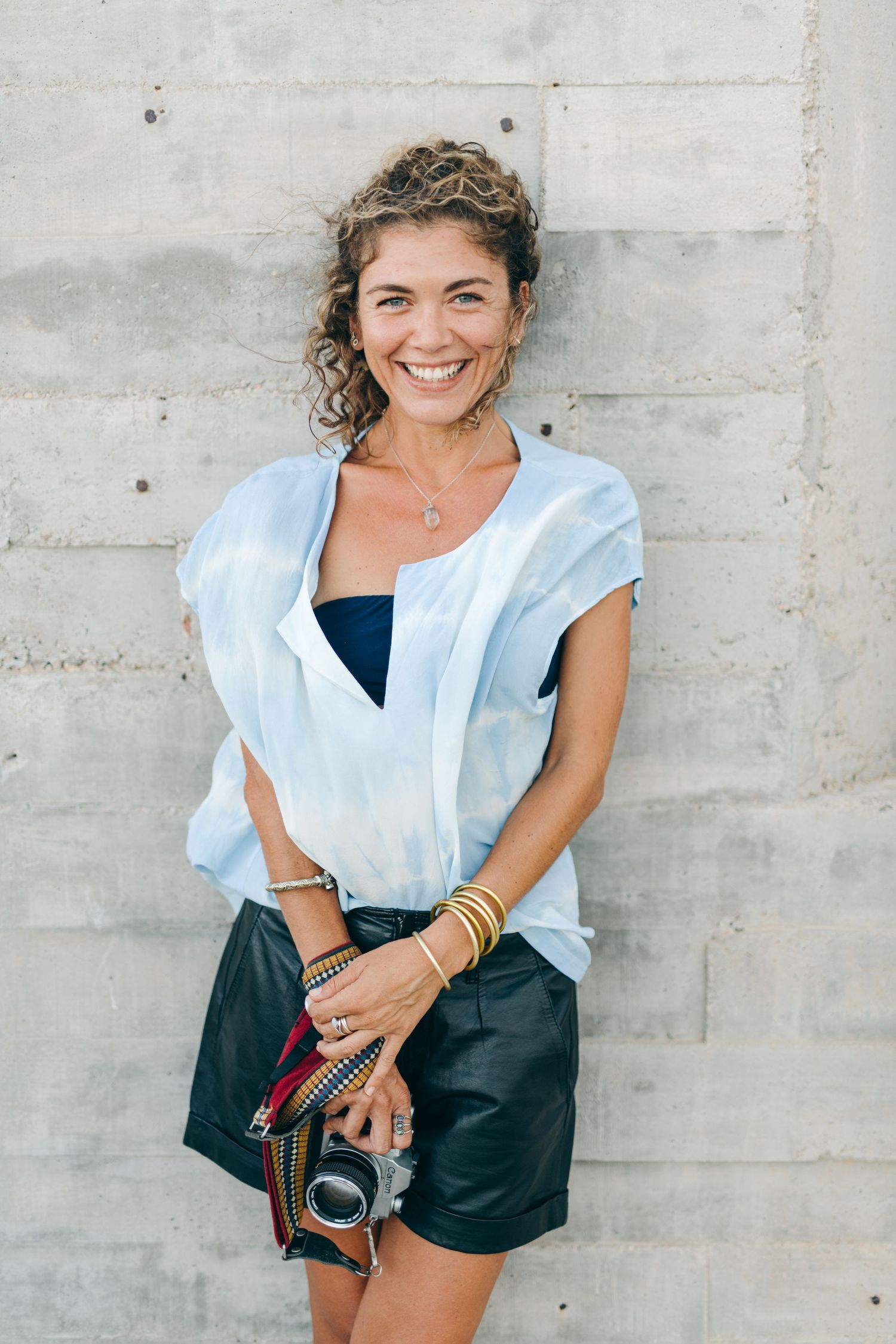 Smiling woman with curly hair blowing in the wind Giada Aline