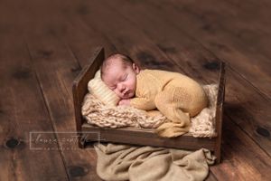 newborn portrait sleeping on bed