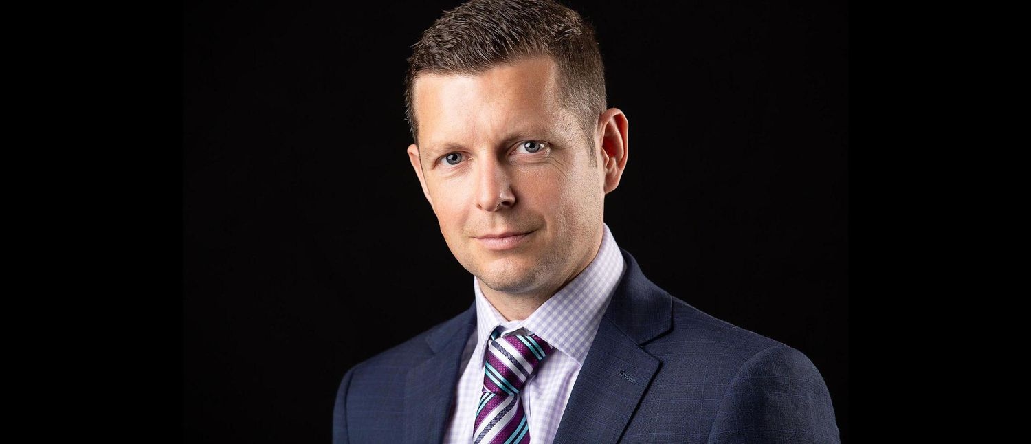 Business headshot on black background