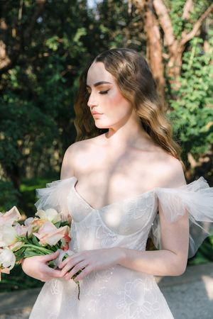 Dappled light portrait of a bride in her Elli Nicole couture dress in South Africa.
