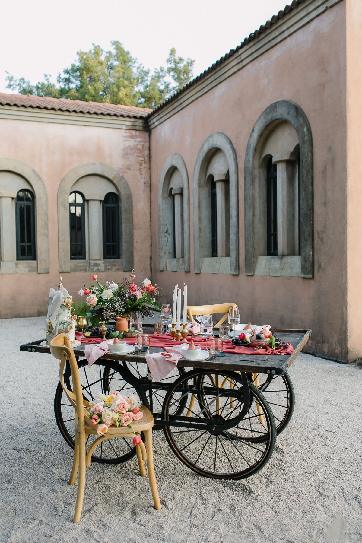A table set for a feast with fruit and flowers.