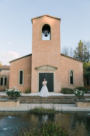 An Italian chapel with a bride standing in the front.