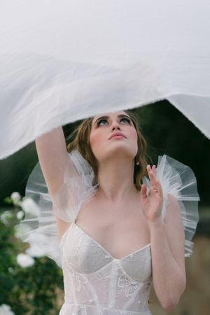 A woman looks up at her veil on her wedding day in South Africa.