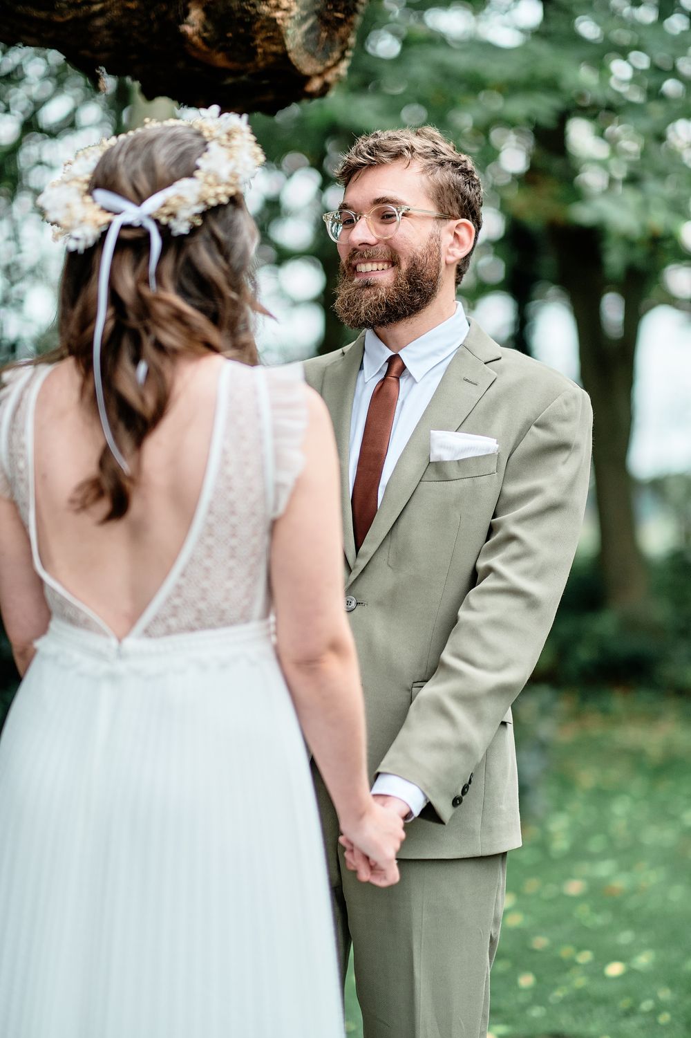 A romantic moment between newlyweds as they exchange vows in an outdoor garden wedding ceremony.